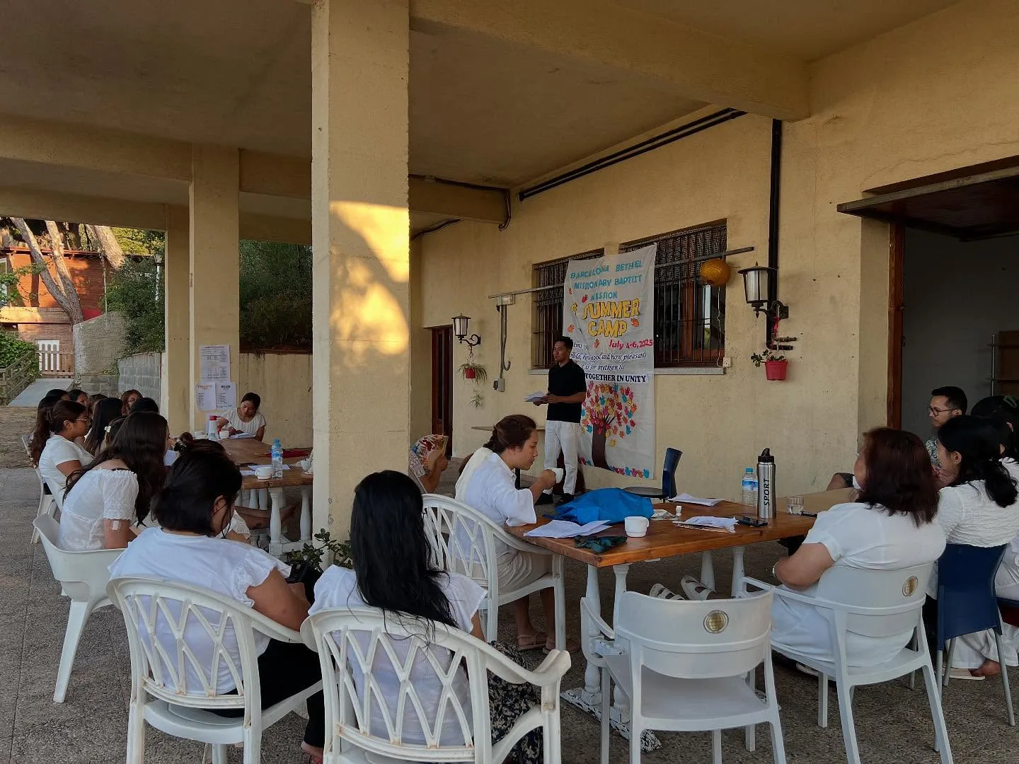 Camp participants gathered around tables for a lesson