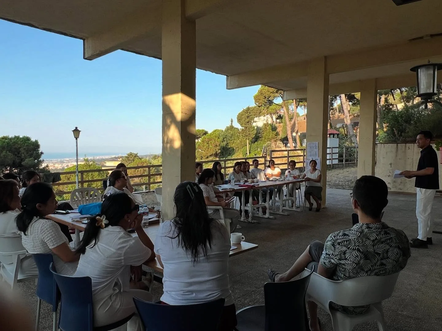 Church camp gathering on a shaded outdoor terrace