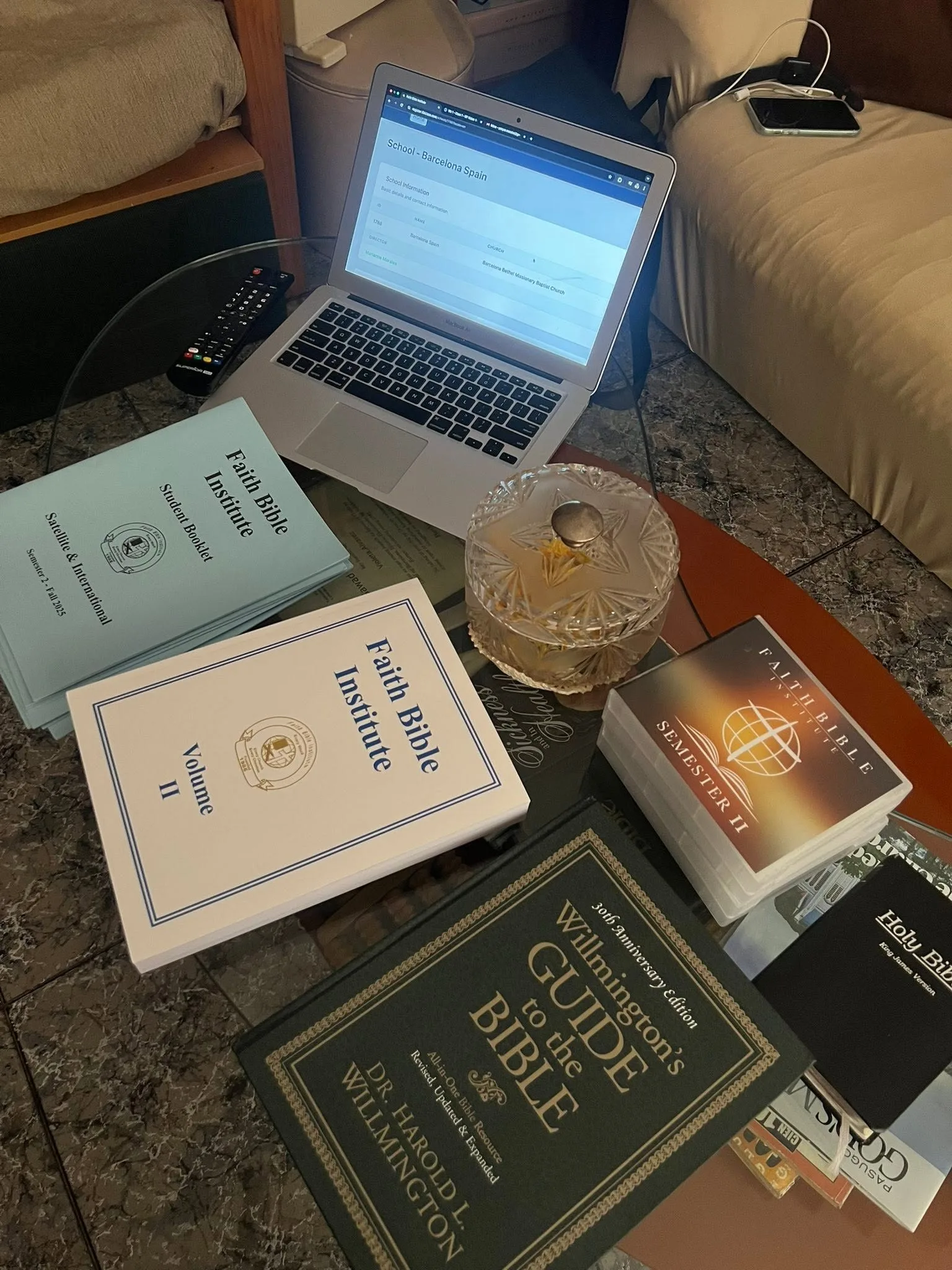 Bible study materials and a laptop ready for a Faith Bible Institute lesson